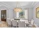 Chic dining room with modern lighting and a large window overlooking the greenery at 5638 Timber Ln, Charlotte, NC 28270
