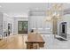 Bright kitchen with large island, stainless appliances, and double doors leading to another room at 5638 Timber Ln, Charlotte, NC 28270