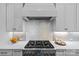 Close-up of a modern kitchen features a stainless steel range and white tile backsplash at 5638 Timber Ln, Charlotte, NC 28270