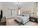 Serene bedroom with soft lighting, a large bed, and a sliding barn door to the bathroom at 5638 Timber Ln, Charlotte, NC 28270