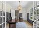 Well-lit office space with wainscoting, a modern desk, and a comfortable chair at 5638 Timber Ln, Charlotte, NC 28270