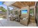 Outdoor living with brickwork, wooden roof, grill, kitchen and cushioned seating area at 5638 Timber Ln, Charlotte, NC 28270