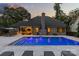 Backyard with an inviting pool illuminated at dusk, alongside a patio and an outdoor lounge area at 5638 Timber Ln, Charlotte, NC 28270