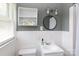 Clean bathroom featuring white tile, a vanity, and a round mirror at 628 Stamie Dr, Chester, SC 29706
