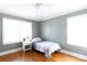Cozy bedroom featuring hardwood floors, a ceiling fan, and ample natural light from two windows at 628 Stamie Dr, Chester, SC 29706