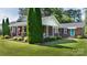 Beautiful brick home with a covered front porch, mature evergreens, and manicured landscaping in a desirable neighborhood at 628 Stamie Dr, Chester, SC 29706