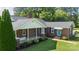 Brick home with charming front porch, mature landscaping, and a side entrance with awning at 628 Stamie Dr, Chester, SC 29706