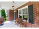 View of cozy front porch with brick details, ceiling fan, and outdoor seating at 628 Stamie Dr, Chester, SC 29706