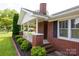 Charming brick home with a covered front porch featuring a swing and lush landscaping at 628 Stamie Dr, Chester, SC 29706