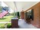 Charming brick home with a covered front porch featuring an inviting seating area at 628 Stamie Dr, Chester, SC 29706