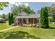 Inviting brick home with a charming front porch, decorative shrubs, and a well-maintained lawn and walkway at 628 Stamie Dr, Chester, SC 29706
