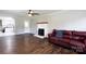 Open living room with hardwood floors, a fireplace, and views into the kitchen and backyard at 628 Stamie Dr, Chester, SC 29706