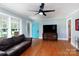 Bright living room with hardwood floors, a ceiling fan, and a blue front door at 628 Stamie Dr, Chester, SC 29706