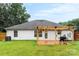 Exterior of home featuring a backyard with wood deck, pergola, and lush green lawn at 7144 Marlin St, Gastonia, NC 28056