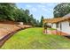 A lovely backyard features a wood deck, a pergola, and a lush lawn at 7144 Marlin St, Gastonia, NC 28056