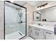 Modern bathroom features a glass enclosed shower, gray vanity, and contemporary fixtures at 7144 Marlin St, Gastonia, NC 28056