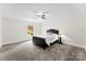 A spacious bedroom features soft gray carpeting, a ceiling fan, and a large window at 7144 Marlin St, Gastonia, NC 28056