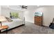 Cozy bedroom features a ceiling fan, natural light, and a dresser with mounted TV at 7144 Marlin St, Gastonia, NC 28056