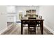 Bright dining room with wooden table and chairs, adjacent to a well-lit backyard at 7144 Marlin St, Gastonia, NC 28056