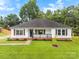 Charming one-story home with a well-maintained lawn and inviting front porch at 7144 Marlin St, Gastonia, NC 28056