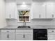 Kitchen featuring granite countertops, white cabinets and black stainless steel appliances at 7144 Marlin St, Gastonia, NC 28056