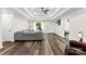Bright living room featuring a tray ceiling, hardwood floors, and comfortable gray sofa at 7144 Marlin St, Gastonia, NC 28056