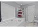 Clean bathroom with a large bathtub, shower, and organized towel storage at 7212 Morsey Ct, Charlotte, NC 28269