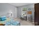 Comfortable bedroom with a dedicated desk space, bright window, and good lighting at 7212 Morsey Ct, Charlotte, NC 28269