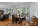 Bright dining area with large windows, a wooden table and seating for six at 7212 Morsey Ct, Charlotte, NC 28269