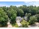 Two-story home with a two-car garage, surrounded by mature trees and a green lawn at 7212 Morsey Ct, Charlotte, NC 28269