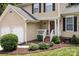 A charming home featuring a well-manicured lawn, complemented by an attached two-car garage and cozy front porch at 7212 Morsey Ct, Charlotte, NC 28269