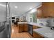 Open kitchen with stainless steel appliances, breakfast bar, and view into the adjacent dining and living areas at 7212 Morsey Ct, Charlotte, NC 28269
