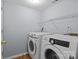 Functional laundry room with modern washer and dryer units, and storage shelf at 7212 Morsey Ct, Charlotte, NC 28269