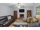 Inviting living room featuring a cozy fireplace, hardwood floors, and neutral color palette at 7212 Morsey Ct, Charlotte, NC 28269