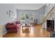 Inviting living room with hardwood floors, large windows, and cozy seating arrangement at 7212 Morsey Ct, Charlotte, NC 28269