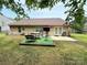 Beautiful backyard with patio, picnic table, and ample green space for outdoor enjoyment at 7267 Sandown Ct, Harrisburg, NC 28075