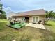 A spacious backyard, featuring a lawn and patio area with table and chairs for outdoor entertaining at 7267 Sandown Ct, Harrisburg, NC 28075