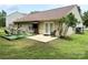 Backyard features a grassy lawn and patio, perfect for relaxation and outdoor activities at 7267 Sandown Ct, Harrisburg, NC 28075