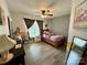 Charming bedroom featuring a twin bed, ceiling fan, and wall decor at 7267 Sandown Ct, Harrisburg, NC 28075