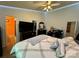 Inviting bedroom with ceiling fan, wood floors, TV, and ample space for relaxing and sleeping at 7267 Sandown Ct, Harrisburg, NC 28075