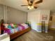 Bedroom featuring a cozy twin bed, ceiling fan, and unique decor at 7267 Sandown Ct, Harrisburg, NC 28075