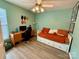 Green bedroom with desk, daybed and overhead lighting at 7267 Sandown Ct, Harrisburg, NC 28075