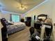 Spacious bedroom featuring vaulted ceiling, ceiling fan, wood floors, and plenty of natural light at 7267 Sandown Ct, Harrisburg, NC 28075