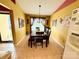 Well-lit dining room with tile floor, a dining table, and a sliding glass door at 7267 Sandown Ct, Harrisburg, NC 28075