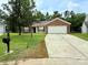 Charming brick and vinyl home featuring an expansive driveway and two car garage at 7267 Sandown Ct, Harrisburg, NC 28075
