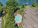 Aerial view of a community pool with lounge chairs and landscaping, near waterfront property at 7845 Village Harbor Dr, Cornelius, NC 28031