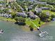 Stunning aerial view of waterfront condos featuring a private dock, boat slip, and tranquil lake access at 7845 Village Harbor Dr, Cornelius, NC 28031
