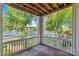 Balcony view of lake with lush green trees, wood decking, and white railing at 7845 Village Harbor Dr, Cornelius, NC 28031