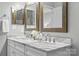 Bathroom featuring double vanity sinks with granite counter tops and framed mirrors at 7845 Village Harbor Dr, Cornelius, NC 28031