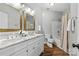 Bathroom featuring a double vanity with marble countertop, mirrors, and a shower-tub combo at 7845 Village Harbor Dr, Cornelius, NC 28031